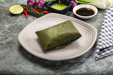 Asian cuisine - rice with filling in banana leaf