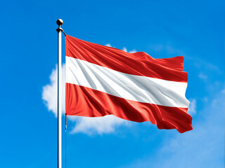 austria flag flying on blur blue clouds background.