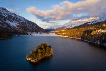 Lake Sils, Switzerland: Dramatic aerial view of the sunset over the Silsersee lake in winter in the Engadine valley in Canton Graubunden in the Swiss alps.
