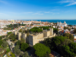 Lisbon, Portugal: Aerial drone view of the Lisbon medieval castle in the old town in Portugal capital city with the Tages river in the background