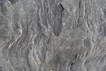 Rocks worn by wind and sea found on a wild beach, which is part of a geopark.