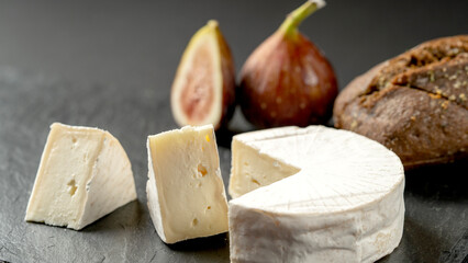 Cheese on a plate with figs and blueberries