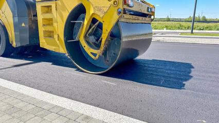 Roller lays new asphalt on the road