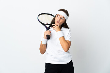 Young woman tennis player over isolated white background having doubts while looking up
