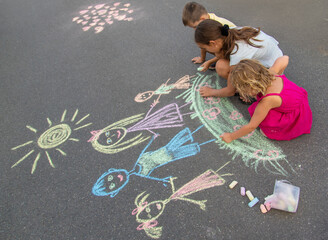 children draw a family with chalk. Selective focus