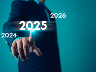 Businessman point finger at text 2025, Set goals for 2025,  Implementation of business goals plan, Development to achieve goals and success, Changes in new planning, Business growth.