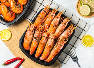 Salted Grilled Shrimp with Lemon and fork served in black tray isolated on table top view of taiwan seafood