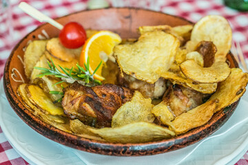 Traditional portuguese food: Grilled chicken with orange sauce, potatoes and rosemary, ready-to-eat