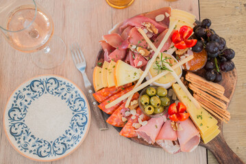 Portuguese charcuterie plate with ham, different cheeses and bread, directly above