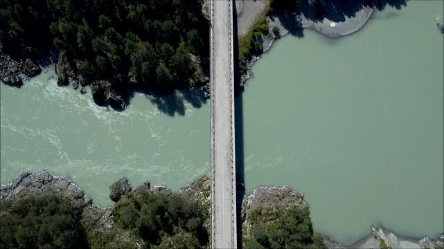Aerial view of Butin's bridge over Rh&ocirc;ne river in autumn, Geneva, Switzerland. Vue a&eacute;rienne du pont Butin au dessus de la rivi&egrave;re du Rh&ocirc;ne film&eacute;e par un drone en automne, 4k. Gen&egrave;ve, Suisse.