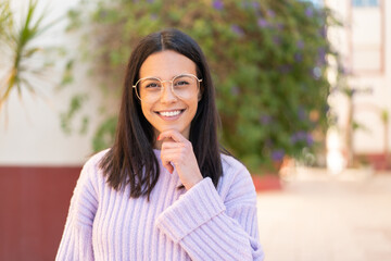 Young woman at outdoors With happy expression