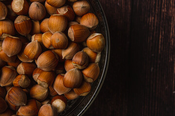 Hazelnuts and nutcracker on wooden background