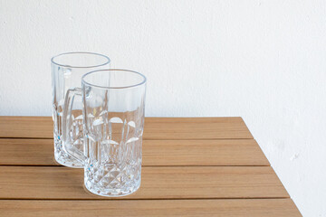 Two empty beer mugs on a wooden table, perfect for Octoberfest celebrations, awaiting a fresh pour