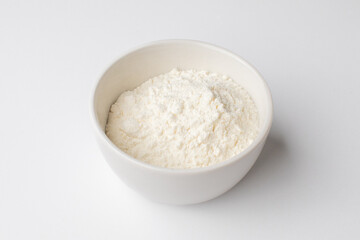 Bowl of white cornstarch on a plain background, essential ingredient for baking and cooking during holiday season