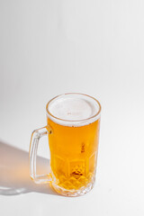 A frosty mug of golden beer, perfect for celebrating Oktoberfest or relaxing on a hot summer day