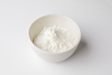 A bowl of white flour on a clean surface, perfect for Christmas holiday baking and culinary preparations