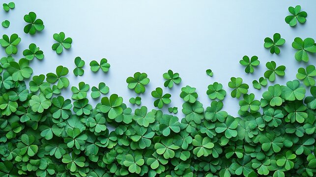 St. Patrick's Day banner design flat lay with green paper, four-leaf clover, and confetti on a white background.