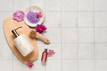 Beautiful spa composition with orchid flowers on light tile background