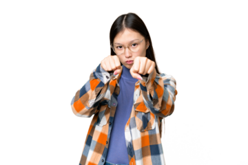 Young Asian woman over isolated chroma key background with fighting gesture