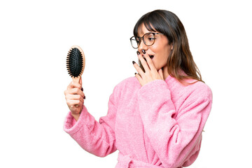 Young woman with hair comb over isolated chroma key background with surprise and shocked facial expression