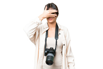 Young photographer caucasian woman over isolated chroma key background covering eyes by hands and smiling