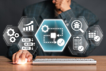A businessman interacting with a digital interface displaying workflow icons, representing...