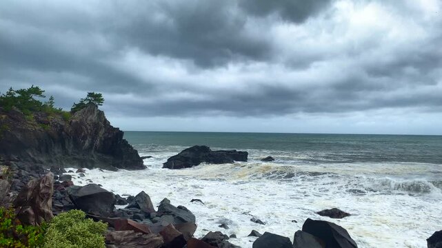 Captivating 4K60P footage of immense waves unleashed by a powerful typhoon. The gray, tumultuous sea showcases the raw and terrifying power of nature, with relentless waves crashing against the coastl