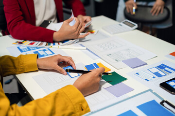 UX developer and ui designer brainstorming about mobile app interface wireframe design with...