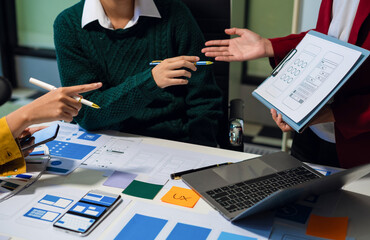 UX developer and ui designer brainstorming about mobile app interface wireframe design with...