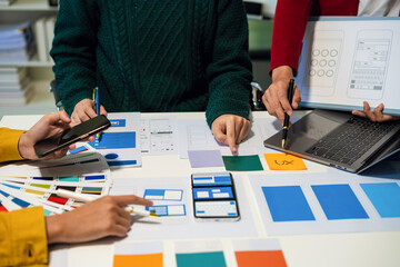 UX developer and ui designer brainstorming about mobile app interface wireframe design with...