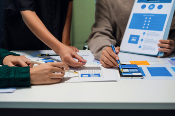 UX developer and ui designer brainstorming about mobile app interface wireframe design with...