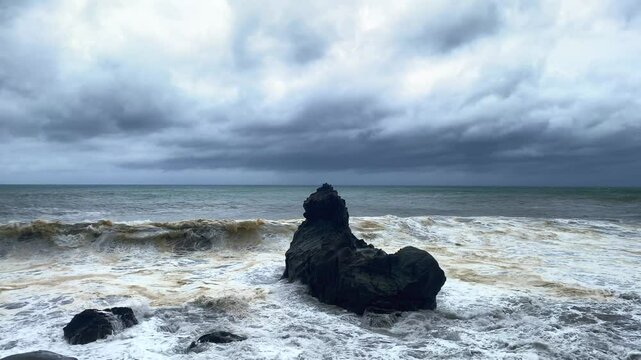 Captivating 4K60P footage of immense waves unleashed by a powerful typhoon. The gray, tumultuous sea showcases the raw and terrifying power of nature, with relentless waves crashing against the coastl