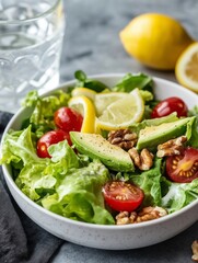 A refreshing salad made of leafy greens, avocado, cherry tomatoes, and nuts