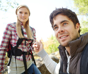 Fototapeta premium Support, helping hand or couple in forest for romantic travel, outdoor adventure or journey. in nature. Love, trip or people in woods together on holiday vacation, mountain or break to explore park