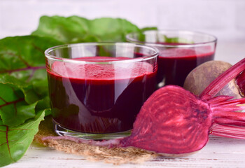 Beetroot juice in low glasses on a white background.Close-up.

