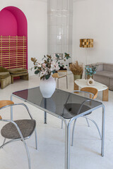 bright interior design of spacious living room with white walls and decorative unique historical moldings on ceiling stylish modern furniture in warm colors without people daylight through the windows