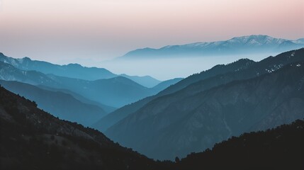 Fototapeta premium serene view of mountain range under soft pink sky