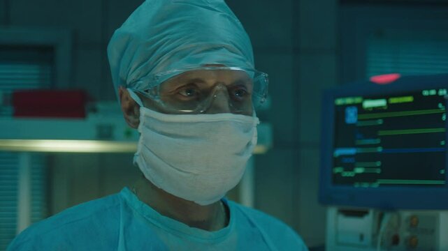 A doctor performing CPR at the hospital and looking at the flat line on the monitor