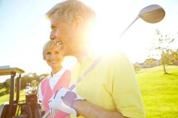 Fototapeta premium Golf course, happy and senior couple with club at sunset for outdoor sports, training and bonding. Smile, man and woman with equipment in nature for retirement hobby, practice and exercise together