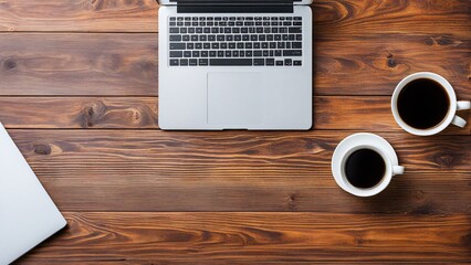Wood office desk table with laptop computer, cup of coffee and supplies. Top view with copy space, flat lay