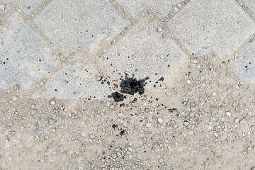 Engine motor oil splash spilled on the ground grease stains drop