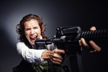 Angry, shooting and woman with gun in studio for secret service, protection and security....
