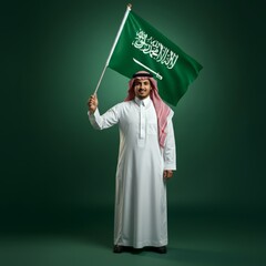 Saudi man holding Saudi Arabia flag isolated on green background, celebration saudi national day or flag day, foundation day.