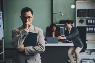 Group of colleagues engaging in a discussion during a business meeting in a conference room. Happy business people, men and women, collaborating and working towards their shared goals.