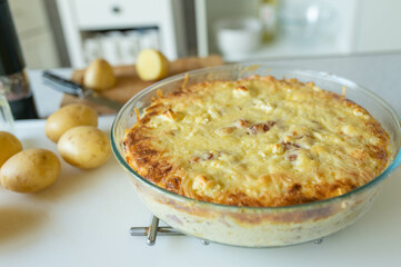 Homemade potato casserole on kitchen counter background