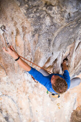 A rock climber ascends to the summit via a difficult route.