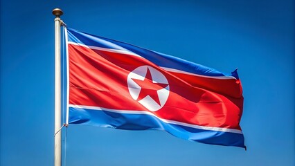 Vibrant red and blue North Korean flag waving proudly in the wind, symbolizing national pride and communist ideology, against a clear blue sky.
