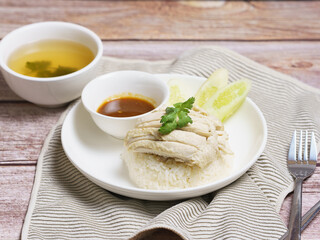 Chicken rice in a white plate on the dining table