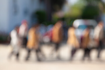 Out-of-focus photo of students walking home from school, capturing the end-of-day routine and movement.