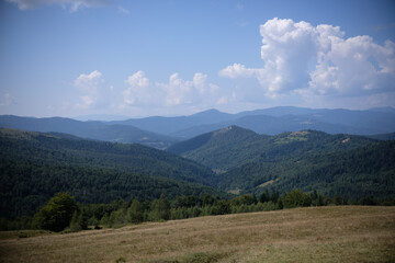 Expansive mountain range under a bright blue sky view